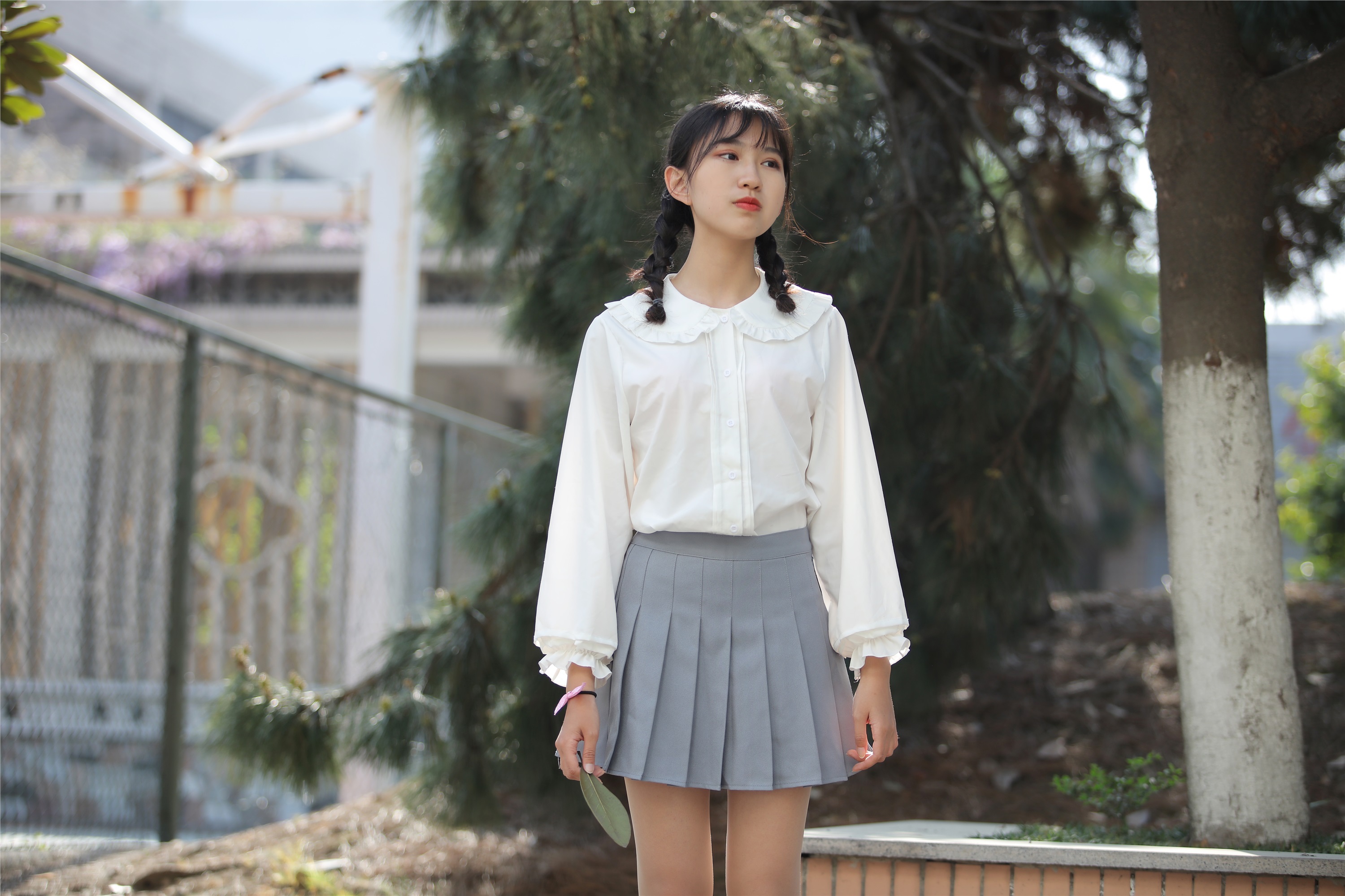 Little Orange with ponytail and white pleated skirt